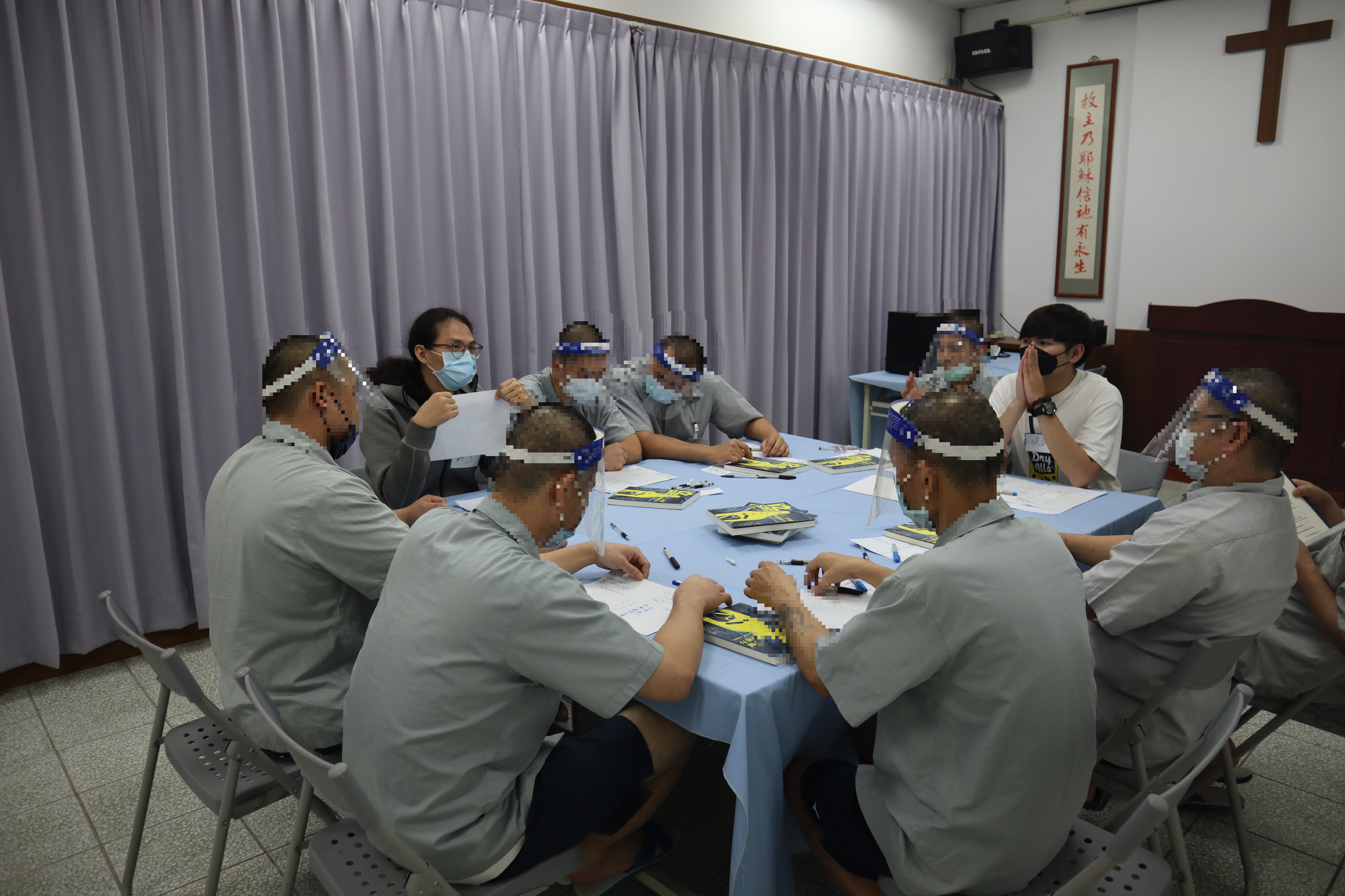 Psychologist showing works to inmates