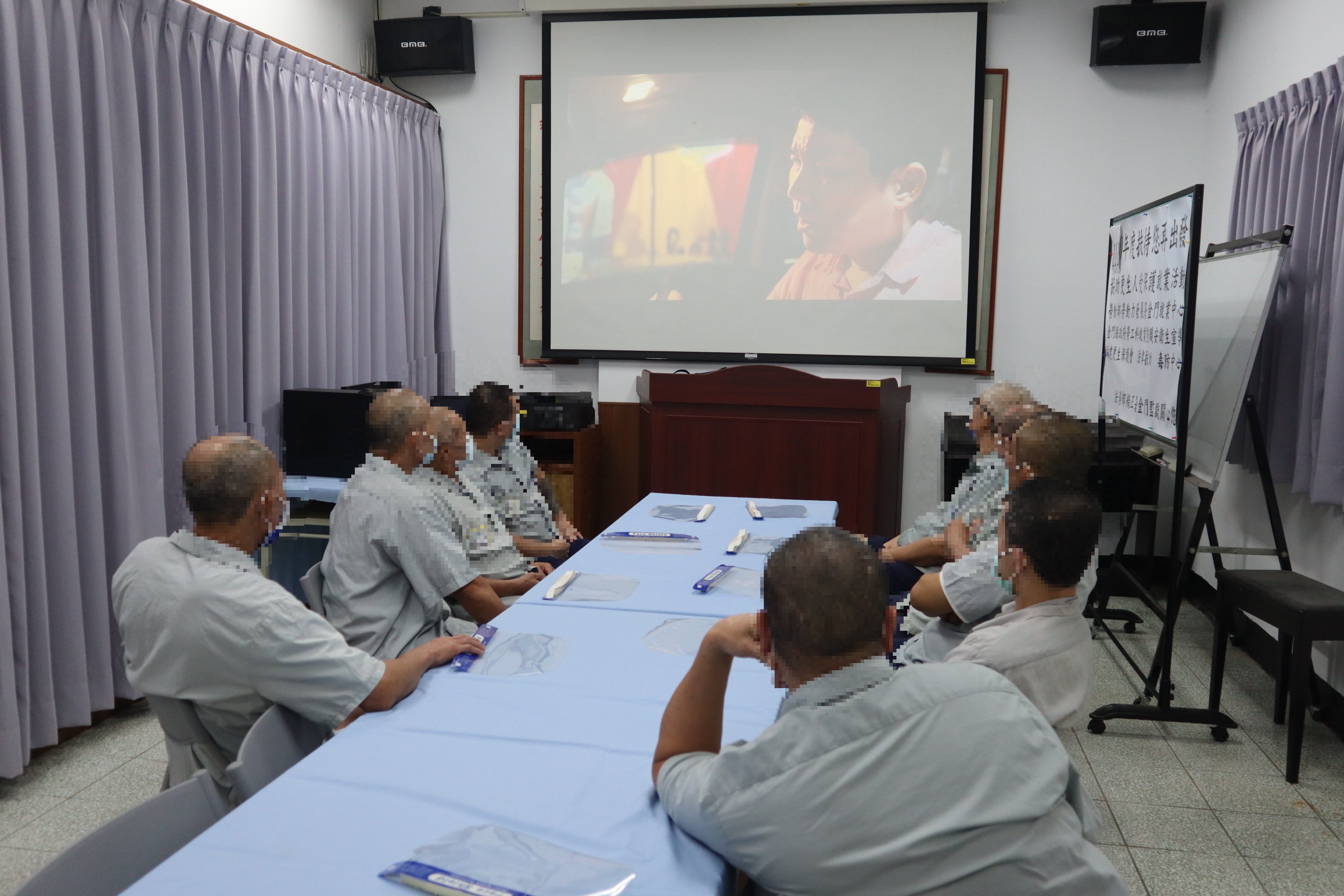 Detainees watch a video about drinking and driving