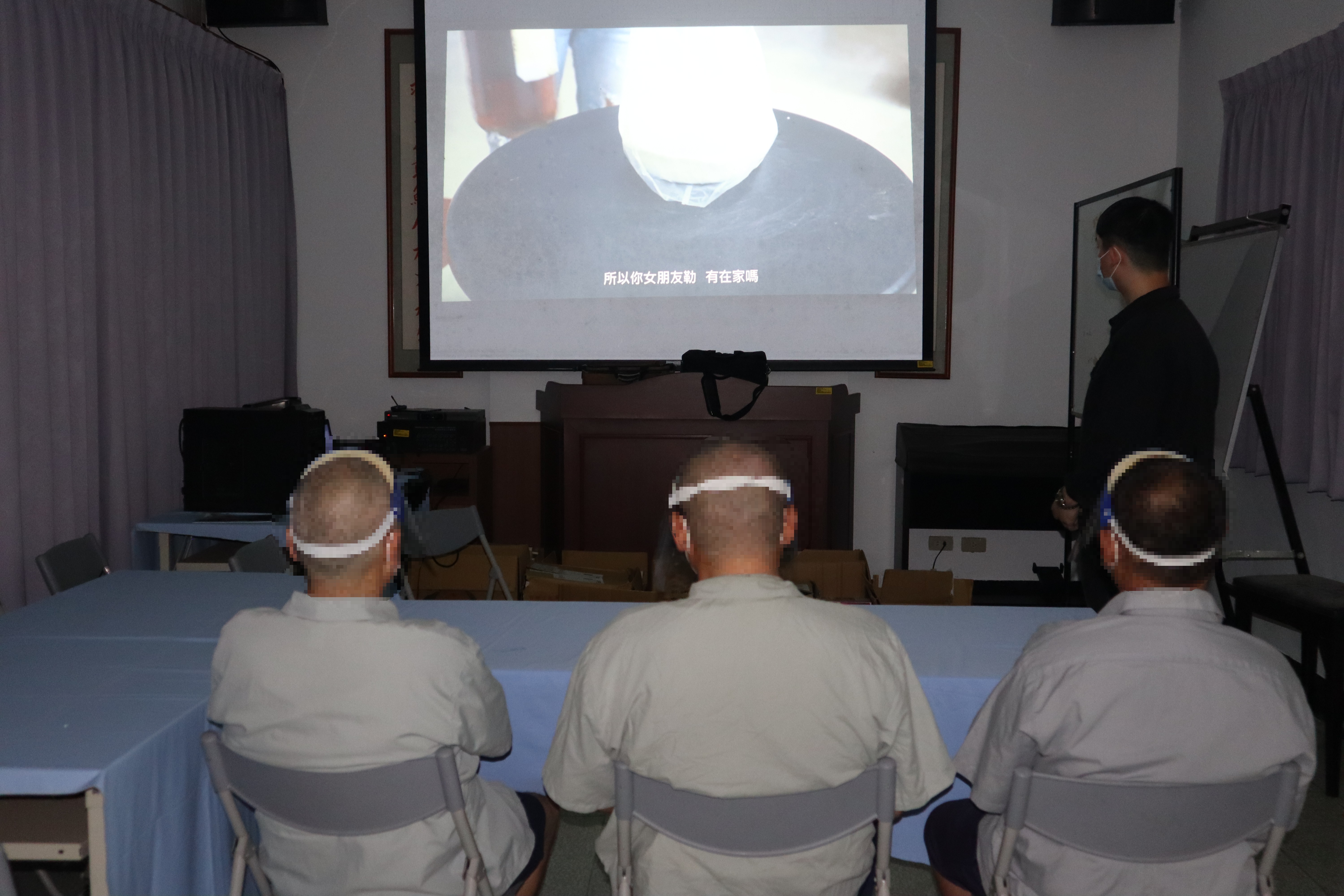 (Social workers play drink-driving-related promotional videos)