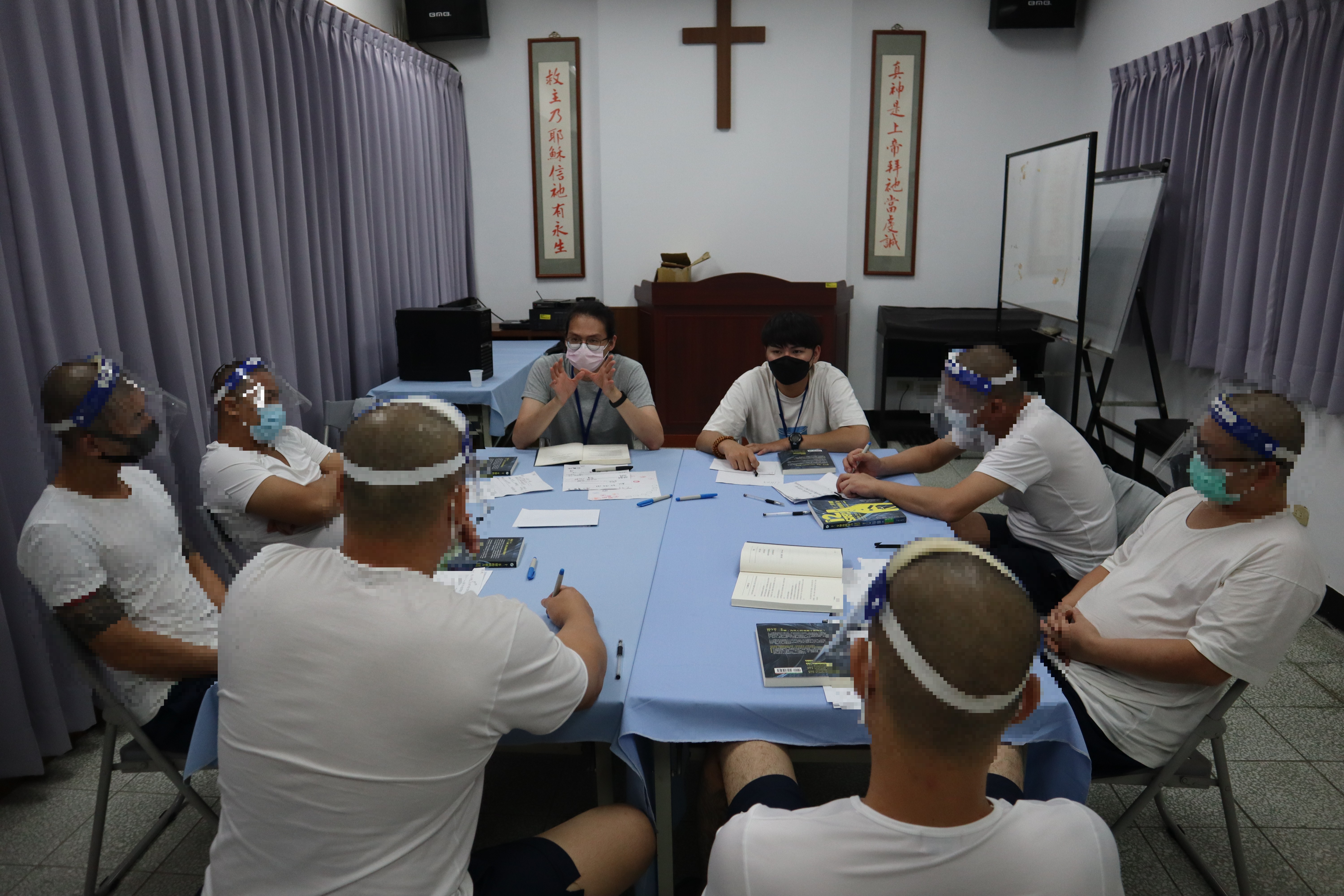 Psychologist reading book with inmate